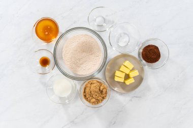 Flat lay. Ingredients in glass mixing bowls to bake chocolate graham crackers.