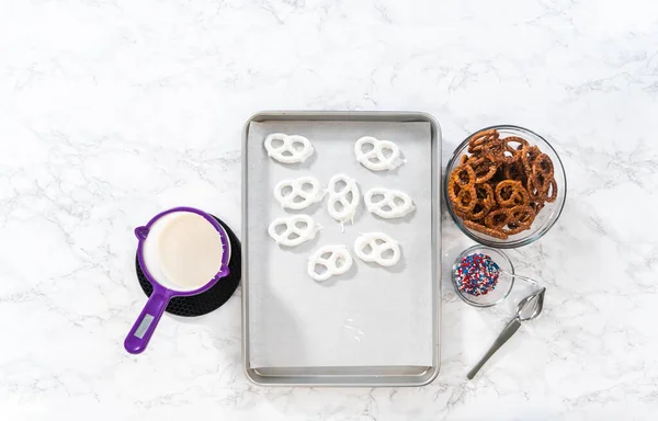 Flat Lay Dipping Pretzels Twists Melted Chocolate Make Red White — Stockfoto