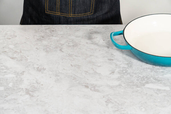 Clean cast iron enameled braiser on the kitchen counter.