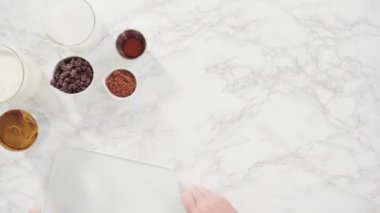 Time lapse. Flat lay. Ingredients on the marble counter to make homemade chocolate ice cream.