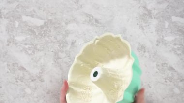 Flat lay. Greasing bundt cake pan with vegetable shortening and flour to bake funfettti bundt cake.