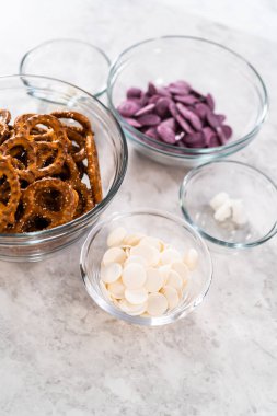 Measured ingredients in glass mixing bowls to make mermaid pretzel twists.