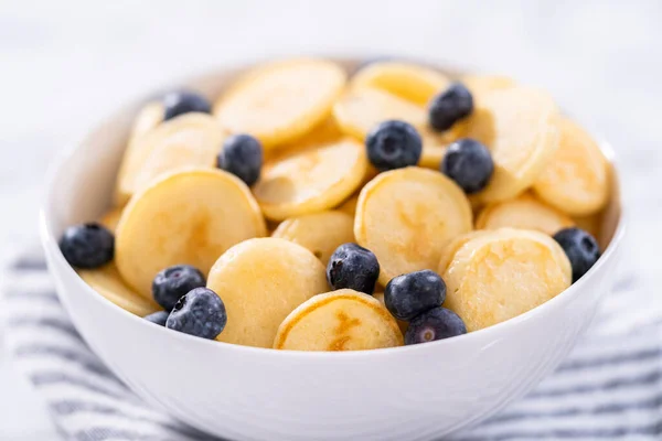 新鲜的迷你煎饼麦片 白碗里有新鲜的蓝莓 — 图库照片