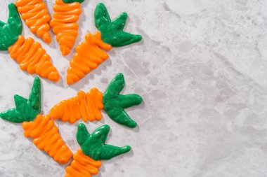 Chocolate carrot cake toppers on a kitchen counter.