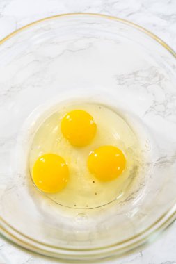 Measured ingredients in glass mixing bowls to bake American flag mini cupcakes.