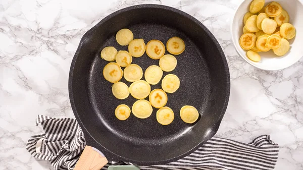 stock image Flat lay. Step by step. Frying mini pancake cereal in a nonstick frying pan.