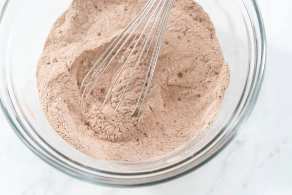 stock image Mixing ingredients in a glass mixing bowl to bake chocolate graham crackers.