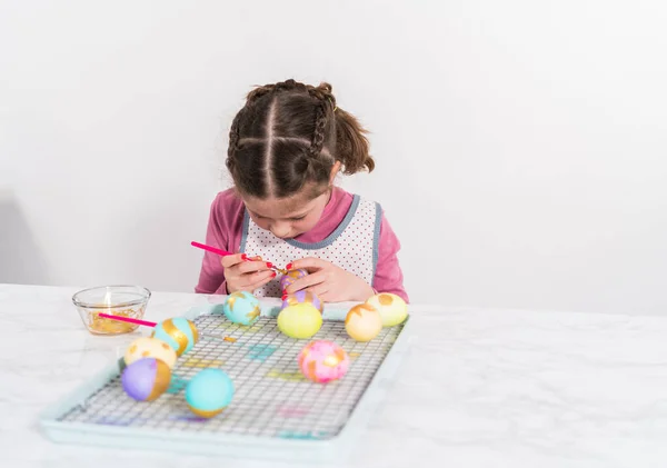 stock image Easter egg coloring. Painting Easter eggs with gold luster.