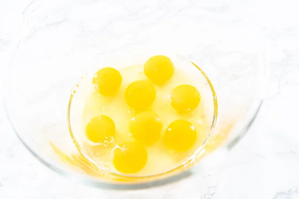 stock image Mixing ingredients in a glass mixing bowl for spinach and ham frittata.