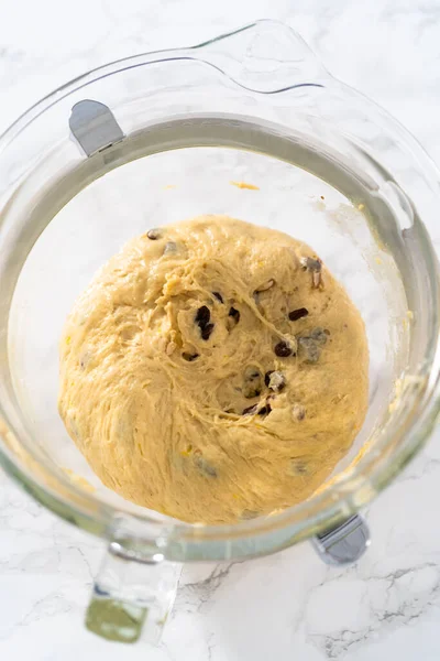 stock image Mixing ingredients in kitchen mixer to bake mini Easter bread kulich.