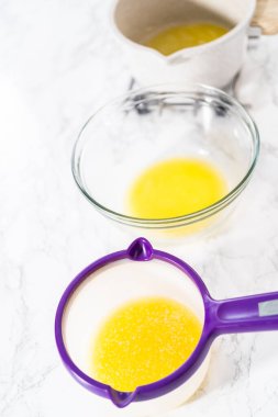 Tezgahta erimiş tuzsuz tereyağı çubukları.