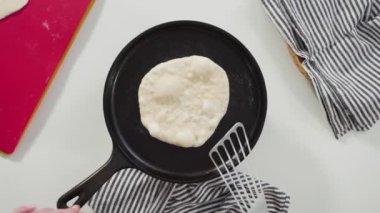 Düz yatıyordu. Dökme demir tavada ev yapımı ekmek hazırlıyorum..