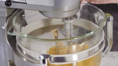 Time lapse. Step by step. Mixing ingredients into the batter for lemon pound cake.