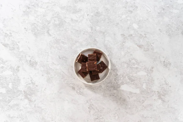 Flat Lay Homemade Chocolate Macadamia Fudge Square Pieces White Plate — Stock Photo, Image