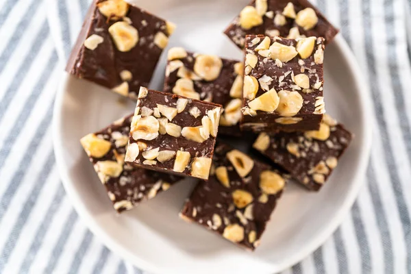 Hausgemachte Schokolade Haselnuss Fudge Quadratische Stücke Auf Einem Weißen Teller — Stockfoto