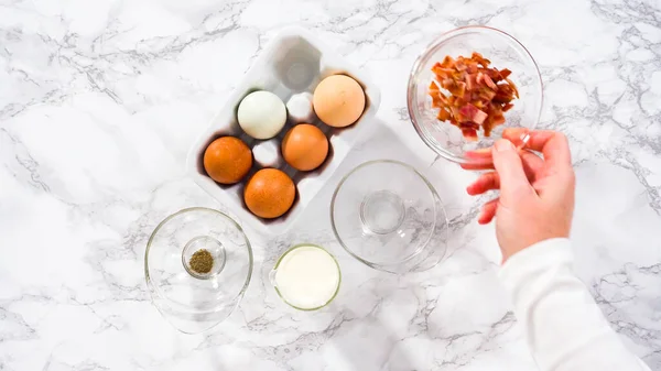 stock image Step by step. Flat lay. Ingredients to prepare bacon and cheese egg muffin.