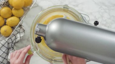 Time lapse. Step by step. Flat lay. Mixing ingredients into the batter for lemon pound cake.