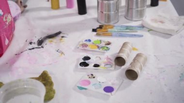 Close up view. Kids papercraft. Making paper bugs out of the empty toilet paper rolls and construction paper.