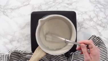 Time lapse. Flat lay. Step by step. Preparing tangzhong in a small saucepan to bake homemade bread.