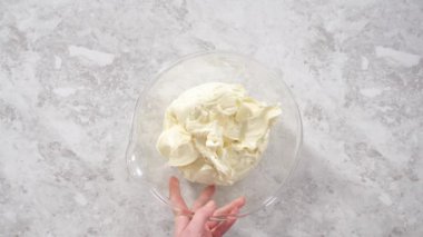 Flat lay. Preparing store-bought buttercream frosting to make unicorn rainbow chocolate cupcakes.