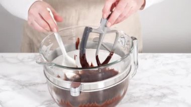 Mixing ingredients in kitchen mixer to bake a chocolate cupcake.