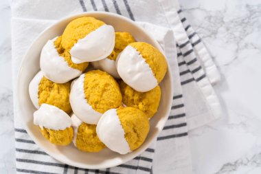 Lemon Cookies with White Chocolate. Freshly baked lemon cookies with white chocolate on a white ceramic plate.