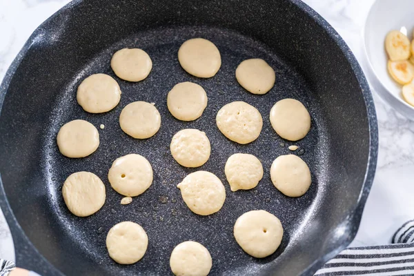stock image Frying mini pancake cereal in a nonstick frying pan.
