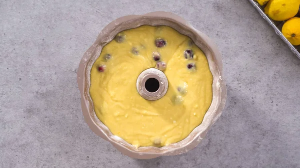 Flat lay. Step by step. Pouring cake batter into the bundt cake pan.