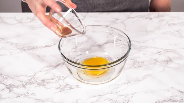 stock image Step by step. Mixing ingredients for mini pancake cereal in a glass mixing bowl.