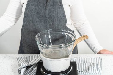 Çikolata parçacıkları ve diğer malzemeleri kaynayan suyun üzerine karıştırıp sade şekerleme hazırlamak..