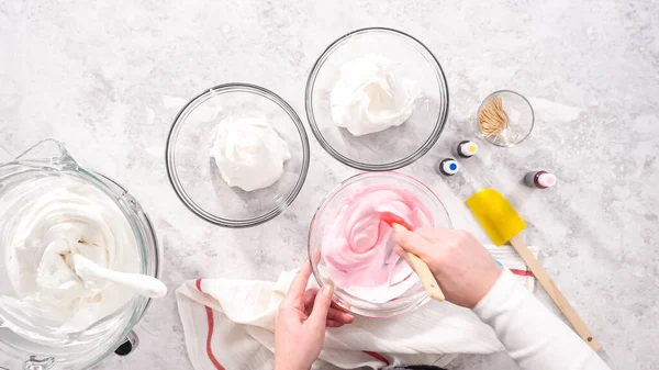 stock image Flat lay. Step by step. Mixing in food coloring into the meringue to bake unicorn meringue pops cookies.