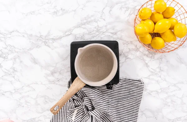 stock image Flat lay. Preparing sugar syrup for bundt cake in a saucepan.