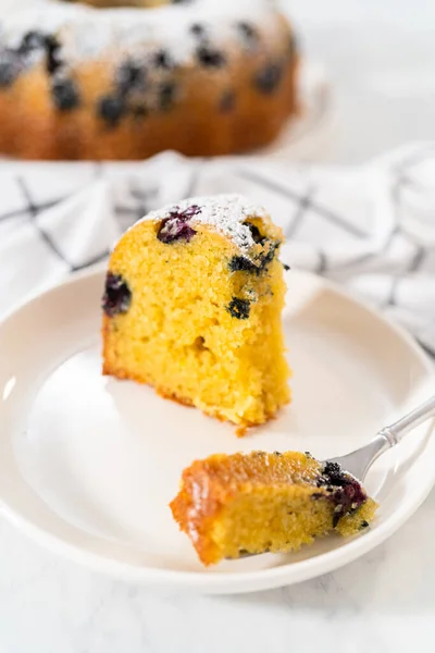 Slicing Freshly Baked Lemon Blueberry Bundt Cake Powdered Sugar Dusting — Stock Photo, Image