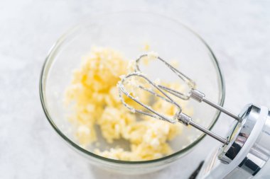 4 Temmuz pastasını çikolatalı yıldızlarla karıştırmak için cam bir kasenin içindekileri karıştırıyorum..