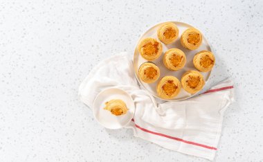 Flat lay. Freshly baked dulce de leche cupcakes on a kitchen counter.
