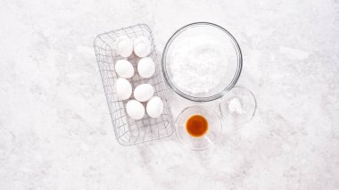 Flat lay. Step by step. Ingredients in glass mixing bowls to prepare unicorn meringue pops cookies.