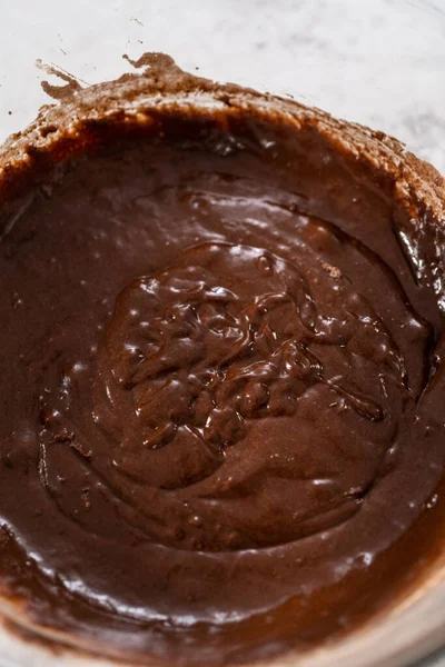 ガラス製のボウルに材料を混ぜ ブレンド泡立て器でチョコレートストロベリーカップケーキを焼く — ストック写真