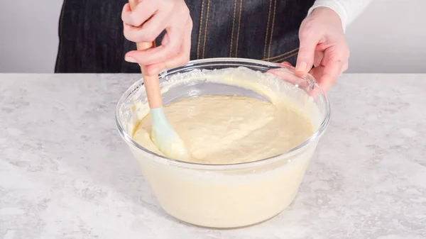 stock image Step by step. Mixing ingredients in a glass mixing bowl to prepare coconut banana pancakes.