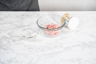 Denver, Colorado, USA-December 18, 2021 - Measured ingredients in a glass mixing bowl to prepare peppermint buttercream frosting.