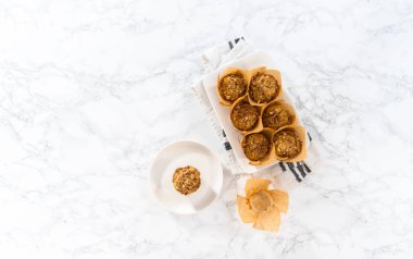 Flat lay. Freshly baked banana oatmeal muffins with oatmeal sugar topping.