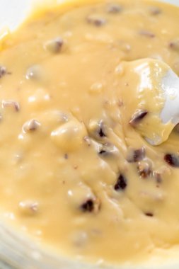 Beyaz çikolata parçacıkları ve diğer malzemeleri kaynamış suyun üzerine karıştırıp beyaz çikolatalı fındıklı fındıklı çikolata hazırlıyorum..