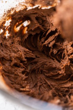 Mixing ingredients with a hand mixer to bake chocolate cookies with chocolate hearts for Valentines Day.