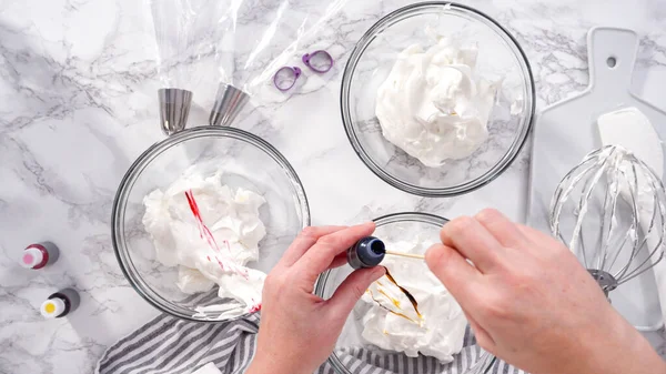 stock image Step by step. Flat lay. Mixing food coloring into the meringue to bake unicorn meringue cookies.