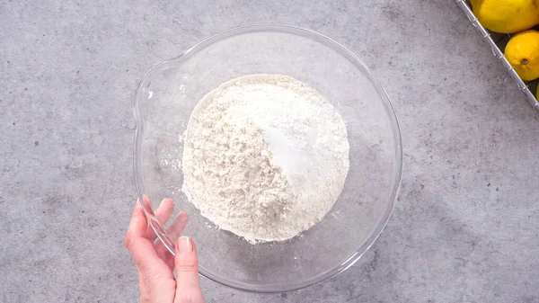 stock image Flat lay. Step by step. Mixing ingredients in a glass mixing bowl to prepare lemon cranberry bundt cake.