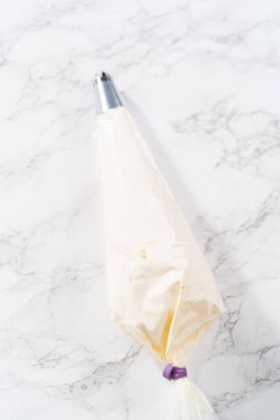 Metal tip with piping bag ready for buttercream frosting.