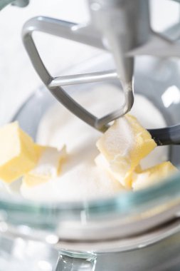 Mixing ingredients in kitchen electric mixer to bake American flag mini cupcakes.