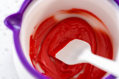 Melting chocolate chips in a candy melting pot to make a chocolate pretzel Christmas wreath.