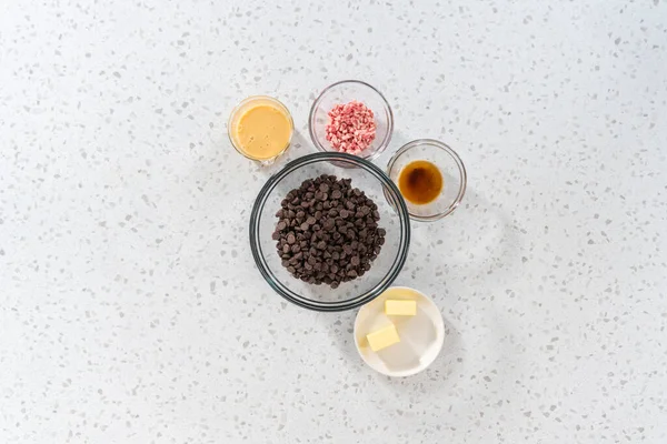 stock image Flat lay. Measured ingredients in glass mixing bowls to make Christmas cookie-cutter peppermint fudge.