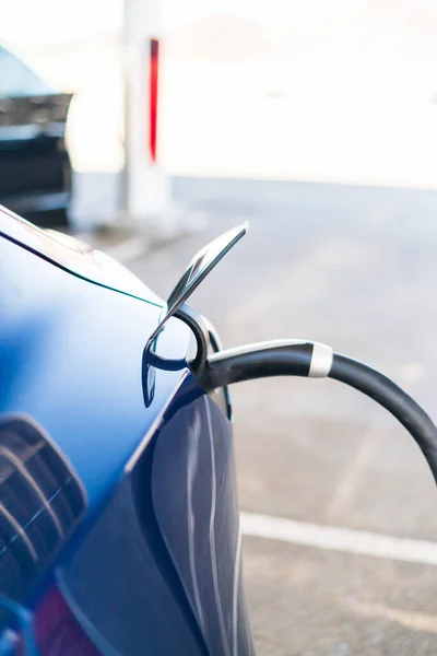 Stock image Baker, California, USA-October 12, 2021 - Tesla supercharging station during the day.