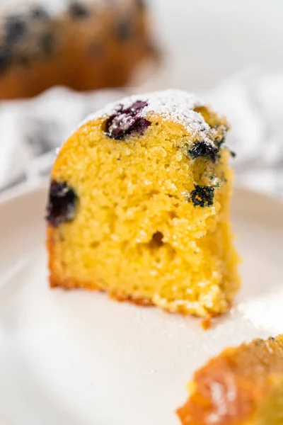 Slicing Freshly Baked Lemon Blueberry Bundt Cake Powdered Sugar Dusting — Stock Photo, Image